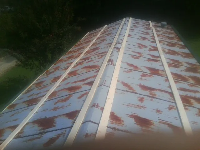 Rusted metal roof panels with new wood purlins before replacement — Storm Damage Roof Repair in Grizzly Flats by Roofing Brothers