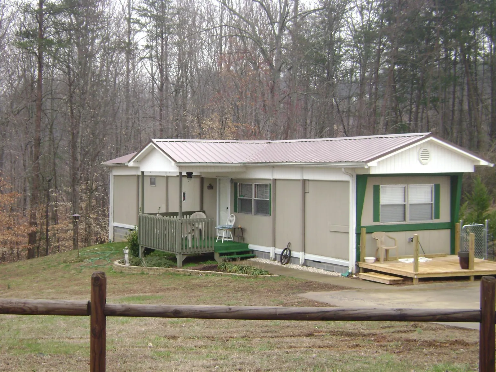 Mauve metal roof on a manufactured home with a new front deck in Grizzly Flats